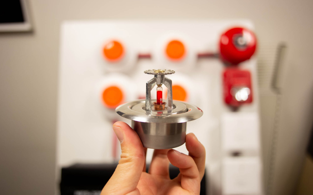 Close up view of a person holding sprinkler head