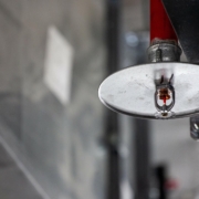 Close up view of a fire sprinkler with spray pan