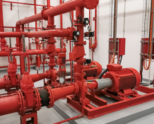 View at industrial electrically powered water pumps and pipes