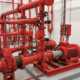 View at industrial electrically powered water pumps and pipes