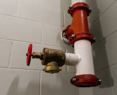 fire hose standpipe system strategy in stairwell with concrete wall background
